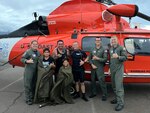 Lt. Olivia Holt, Petty Officer 1st Class Ethan McKenzie, Petty Officer 3rd Class Owen Maurer and Lt. Titus Creamer, members of an MH-65 Dolphin helicopter crew from Coast Guard Air Station Barbers Point, pose for a photo with a father and his two sons at Kahului Airport in Kahului, Hawaii, Oct. 26, 2024. The aircrew rescued the three people from the water after their 16-foot boat capsized approximately 7 miles south of Lanai. (U.S. Coast Guard photo, courtesy Air Station Barbers Point)
