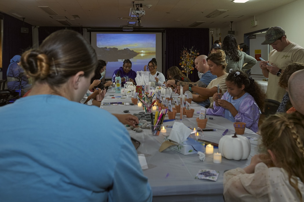 Attendees of a Pregnancy and Infant Loss Remembrance event paint pumpkins and socialize at U.S. Naval Hospital Yokosuka.