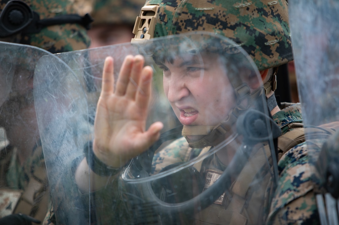U.S. Marine Corps Lance Cpl. Brittyn Smiley, a military police officer with Headquarters and Headquarters Squadron, Marine Corps Air Station Iwakuni, and an Idaho native, braces for an attack as a part of a riot response training during exercise Keen Sword 25 at MCAS Iwakuni, Japan, Oct. 24, 2024. Keen Sword 25 is a biennial, joint and bilateral field-training exercise involving U.S. military and Japan Self-Defense Force personnel, designed to increase readiness and interoperability while strengthening the ironclad U.S.-Japan alliance. (U.S. Marine Corps photo by Sgt. Isaac Orozco)