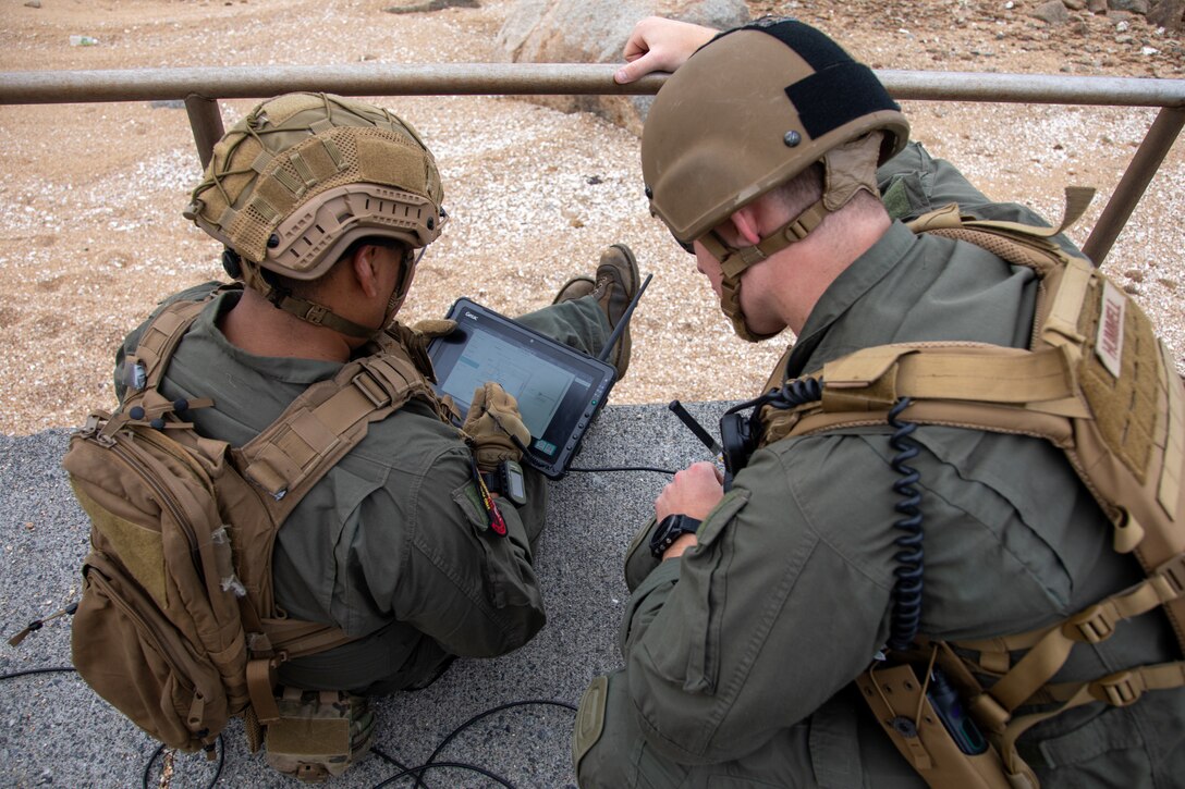 U.S. Marine Corps Staff Sgt. Cesar Martinez, left, an explosive ordnance disposal response element leader and a native of Arizona, and Sgt. Riley Hummel, an explosive ordnance disposal technician and a native of Pennsylvania, both with Explosive Ordnance Disposal, Headquarters and Headquarters Squadron, Marine Corps Air Station Iwakuni, inspect scans of containers with simulated explosive devices and weapons on Target Island during exercise Keen Sword 25 at MCAS Iwakuni, Japan, Oct. 24, 2024. KS25 is a biennial, joint and bilateral field-training exercise involving U.S. military and Japan Self-Defense Force personnel, designed to increase readiness and interoperability while strengthening the ironclad U.S.-Japan alliance. (U.S. Marine Corps photo by Sgt. Randall Whiteman)
