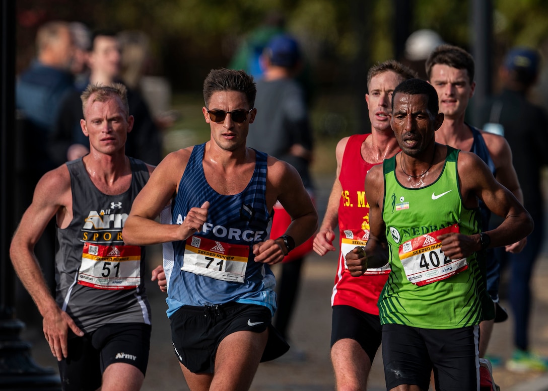 Left: Army Capt Kyle Smith of Fort Carson, Colo. and in center, Air Force Capt George Crist of Travis AFB, Calif. take Armed Forces bronze and silver during the 2024 Armed Forces Marathon Championships held in conjunction with the 49th Marine Corps Marathon on Sunday, October 27th. Service members from the Army, Marine Corps, Navy (with Coast Guard runners, and Air Force (with Space Force runners) go for gold.  Visit www.ArmedForcesSports.defense.gov to learn more about the Armed Forces Sports program and the other sports offered. (Department of Defense photo by MC2 Colby A. Mothershead – released).