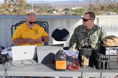 Tim Marshall, a volunteer with ARES and a retired Navy chief petty officer, and Navy Lt. Arion McCartney, Naval Hospital Camp Pendleton Chief Information Officer, discuss amateur radio procedures during the San Diego County 2024 Pediatric Surge Full Scale Exercise on Oct. 24, 2024, aboard Marine Corps Base Camp Pendleton. The hospital’s goals were to practice communication support during an event with degraded communication assets and to stress interoperability and collaboration with other agencies across the county. “We successfully achieved our objectives during this exercise by seamlessly integrating ARES volunteers into our emergency response framework, enabling efficient backup communication, enhancing resource coordination, and providing real-time situational awareness,” said McCartney. “Our successful collaboration with ARES volunteers and partner agencies demonstrated our ability to effectively manage a large-scale disaster scenario, ensuring that critical information and resources were available to support healthcare facilities and protect our community.”