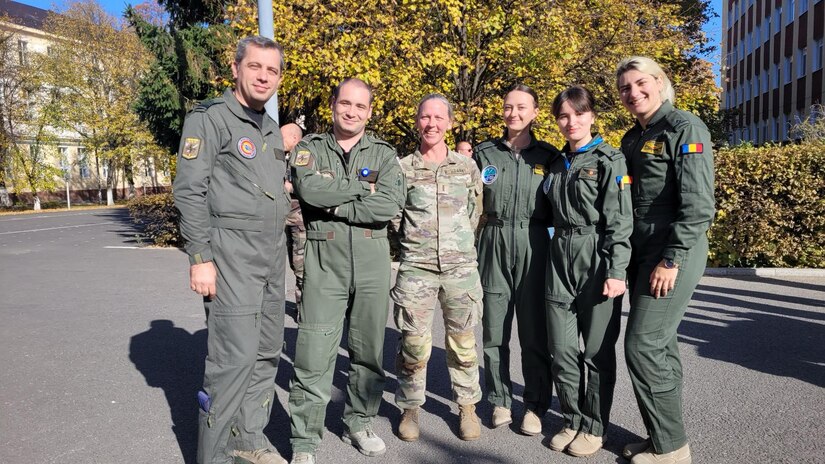 U.S. Army Chief Warrant Officer 4 Rebekah Bell, an aviation planner with V Corps, stands alongside fellow participants of Carpathian Arc in Sibiu, Romania, Oct. 27, 2024. Carpathian Arc is designed to improve interoperability at the staff level and hone lethality among NATO nations.