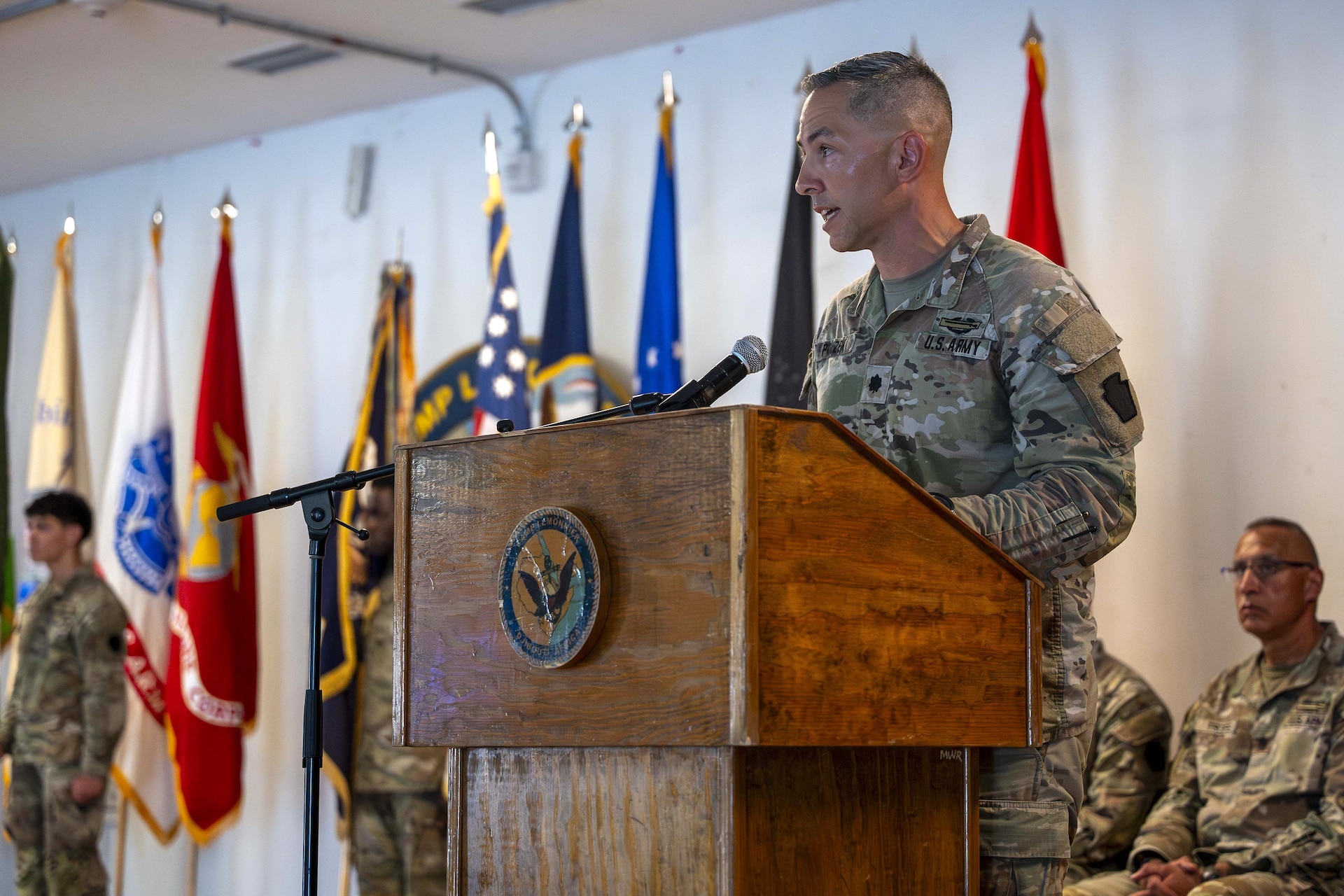 U.S. Army Lt. Col. Eric Ponzek, commander of Task Force Tomahawk, speaks to a distinguished guests and service members from Combined Joint Task Force - Horn of Africa during a transfer of authority ceremony at Camp Lemonnier, Djibouti Oct. 21, 2024. Ponzek highlighted some of the major accomplishments of his task force and thanked his soldiers for their efforts in the security posts across the Horn of Africa. (U.S. Army National Guard photo by SGT. Lark Sine)