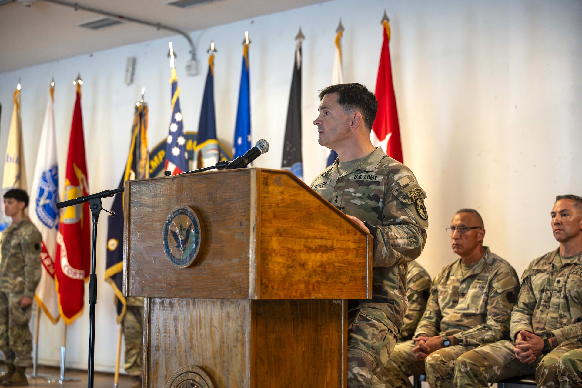 U.S. Army Maj. Gen. Brian Cashman, Combined Joint Task Force - Horn of Africa commanding general, wishes a heartfelt goodbye to the outgoing security forces Task Force, Task Force Paxton, and welcomes the incoming Task Force Associator Soldiers during a transfer of authority ceremony at Camp Lemonnier, Djibouti Oct. 21, 2024. The ceremony is a military tradition representing a formal transfer of authority and responsibility for a mission from one unit to the next. (U.S. Army National Guard photo by SGT. Lark Sine)