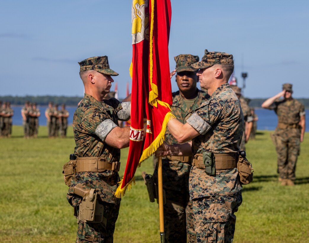 U.S. Marine Corps Lt. Col. Steven J. Siclari, right, the outgoing commanding officer of 2nd Radio Battalion, II Marine Expeditionary Force Information Group, presents the colors and relinquishes command to Lt. Col. Jason E. Gwin, the oncoming commanding officer, during a change of command ceremony at Marine Corps Base Camp Lejeune, North Carolina, July 3, 2024. This change of command ceremony represented the transfer of authorities and responsibilities from Lt. Col. Siclari to Lt. Col. Gwin. (U.S. Marine Corps photo by Sgt. Nathan Mitchell)