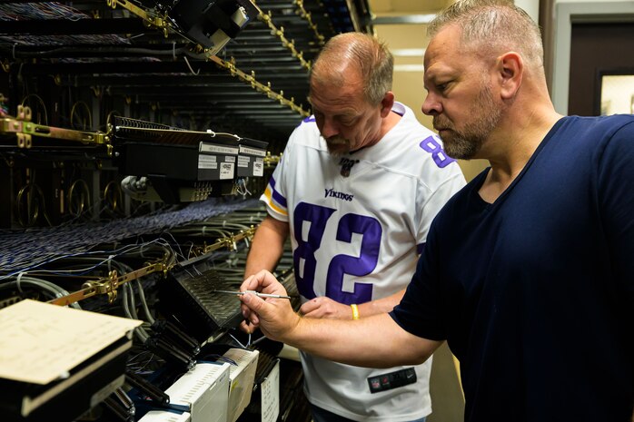 Burke Kilburn and Phil Gardner, 75th Communications and Information Directorate, look at deactivated analog telecommunications components at Hill Air Force Base, Utah. The directorate transitioned to a fully digital system that requires less resources to manage while providing more capabilities.