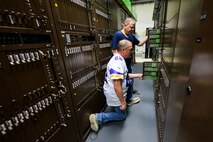Burke Kilburn and Phil Gardner, 75th Communications and Information Directorate, look at deactivated analog telecommunications components at Hill Air Force Base, Utah. The directorate transitioned to a fully digital system that requires less resources to manage while providing more capabilities.