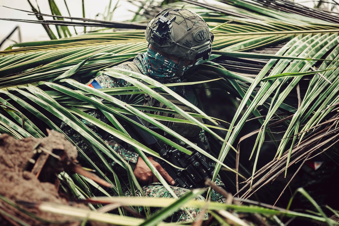 A Philippine Marine assigned to Force Reconnaissance Group prepares to enter a concealed fighting position during a live-fire coastal defense as part of exercise KAMANDAG 8 at Apurawan Beach, Palawan Province, Philippines, Oct. 22, 2024. KAMANDAG is an annual Philippine Marine Corps and U.S. Marine Corps-led exercise aimed at enhancing the Armed Forces of the Philippines’ defense and humanitarian capabilities by providing valuable training in combined operations with foreign militaries in the advancement of a Free and Open Indo-Pacific. This year marks the eighth iteration of this exercise and includes participants from the French Armed Forces, Royal Thai Marine Corps, and Indonesian Marine Corps; including continued participation from the Australian Defense Force, British Armed Forces, Japan Ground Self-Defense Force, and Republic of Korea Marine Corps. (U.S. Marine Corps photo by Cpl. Luis Agostini)