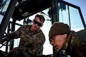 U.S. Air Force Airman Cole Brantley, 305th Aerial Port Squadron transportation specialist, and U.S. Air Force Senior Airman Zir Reamico, 305th APS transportation specialist, inspect a pallet during the APS Rodeo at Joint Base McGuire-Dix-Lakehurst, N.J., Oct. 17, 2024. The APS Rodeo is an annual event held to showcase top performers in an array of transportation challenges that simulate what it is like to work in a high-tempo environment. (U.S. Air Force photo by Senior Airman Matt Porter)