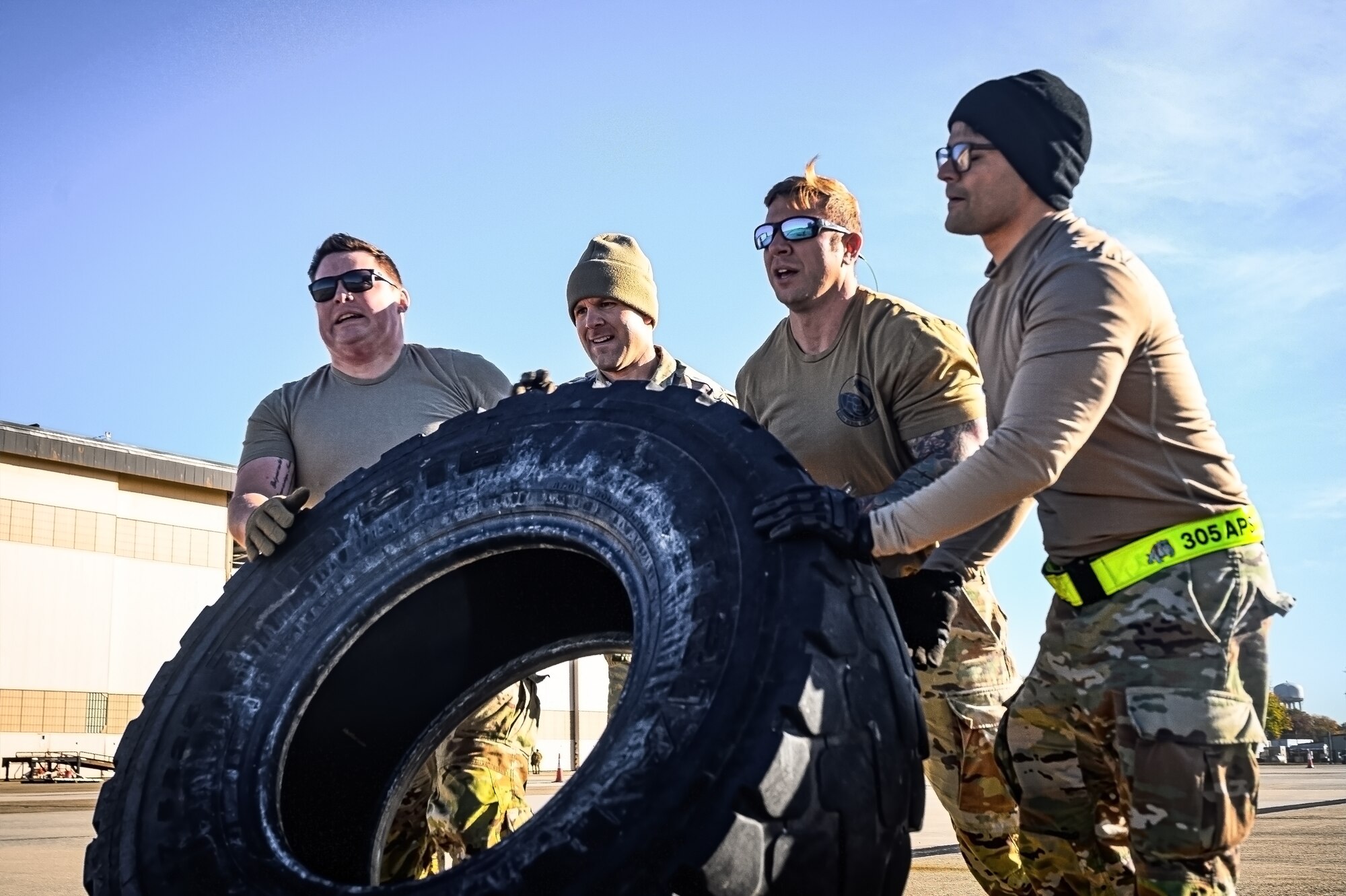 U.S. Air Force air transportation specialists assigned to the 305th Aerial Port Squadron, lift a tire during the APS Rodeo at Joint Base McGuire-Dix-Lakehurst, N.J., Oct. 17, 2024. The APS Rodeo is an annual event held to showcase top performers in an array of transportation challenges that simulate what it is like to work in a high-tempo environment. (U.S. Air Force photo by Senior Airman Matt Porter)