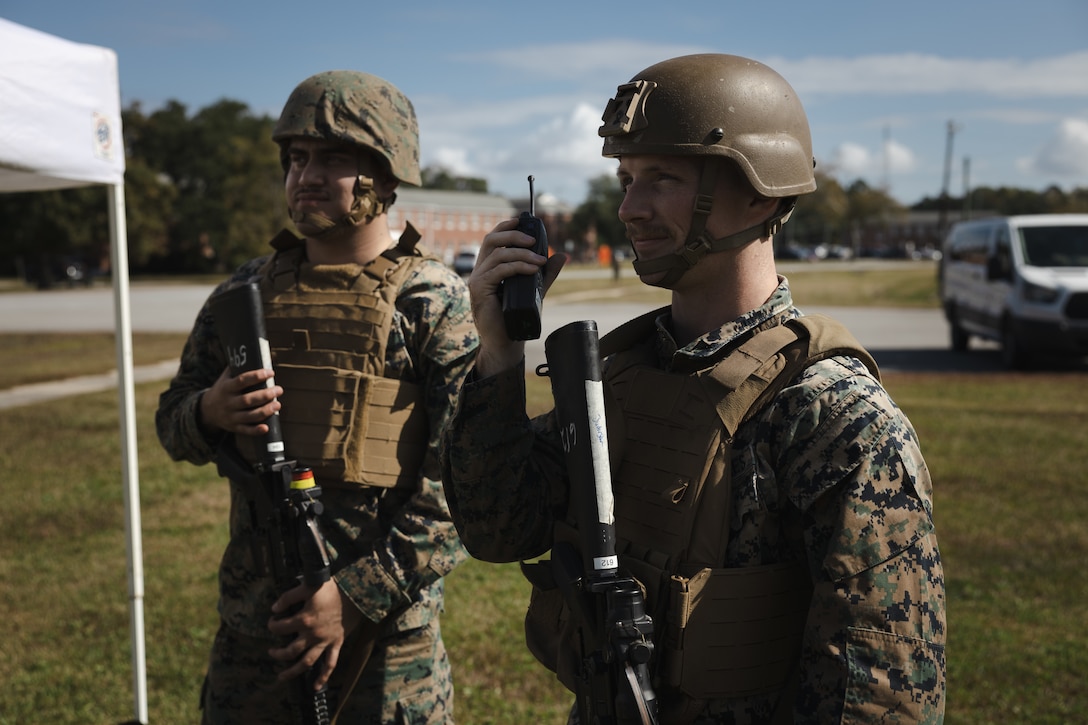 U.S. Marine Corps Cpl. Jorge Perez, left, a supply administration and operation specialist and Lance Cpl. Brindon Juderjohn, a rifleman, both with Headquarters and Support Battalion (H&S Bn), Marine Corps Installations East-Marine Corps Base (MCB) Camp Lejeune conduct communication checks during Exercise Urgent Response on MCB Camp Lejeune, North Carolina, Oct. 23, 2024. H&S Bn Marines conducted identification verification and established vehicle control points in support of Exercise Urgent Response, an installation-wide exercise that provides realistic training opportunities to increase the installation’s emergency response efforts, command and control, and security capabilities. (U.S. Marine Corps photo by Sgt. Khalil Brown)