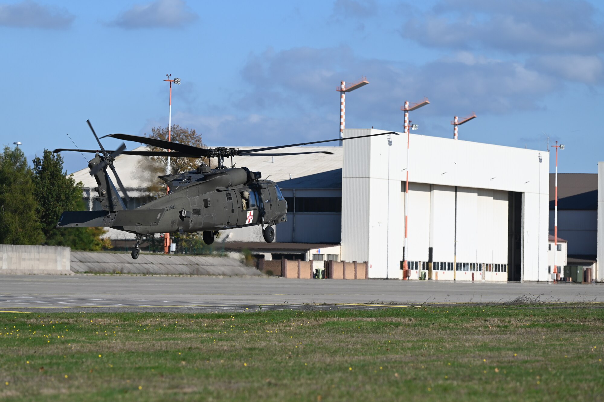 Helicopter flies down flightline.
