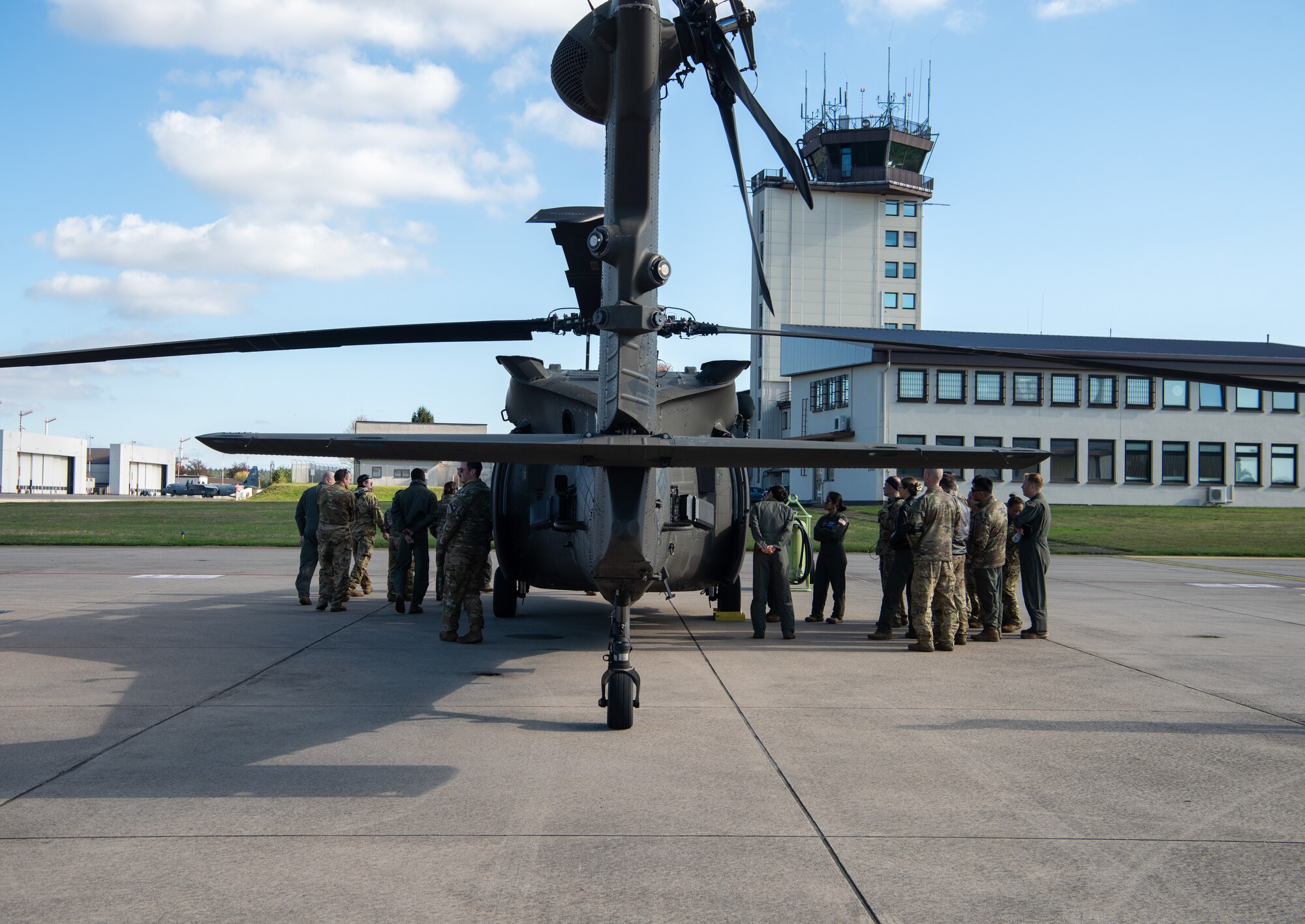 Airmen stand by helicopter.