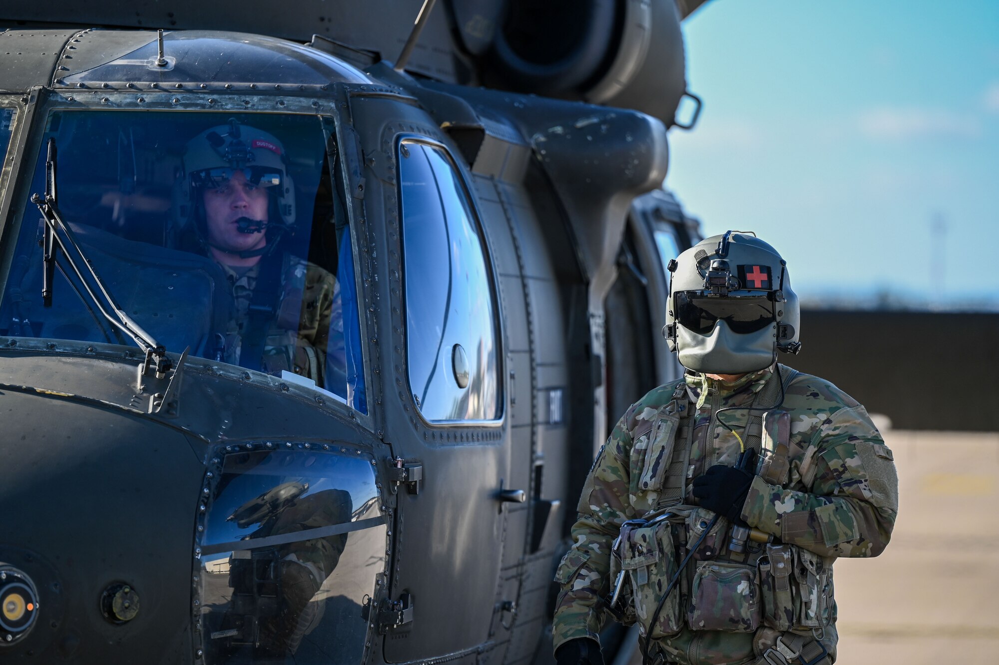 Soldiers stand by helicopter.