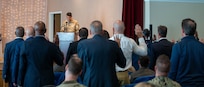 Col. Parker leads the new honorary commanders in the honorary commanders oath.