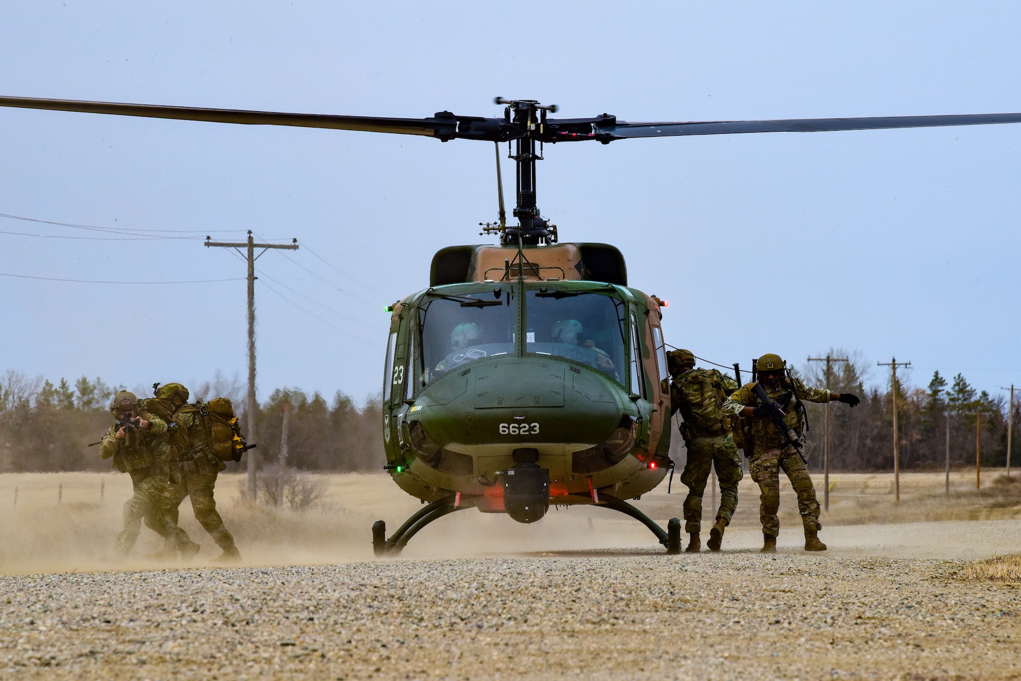 U.S. Airmen assigned to the 91st Missile Security Operations Squadron Tactical Response Force dismount a UH-1N helicopter during a recapture and recovery exercise in support of Global Thunder 23 near Minot Air Force Base, North Dakota, April 28, 2023. Global Thunder is an invaluable training opportunity to exercise all U.S. Strategic Command mission areas and create the conditions for strategic deterrence against a variety of threats. (U.S. Air Force photo by Senior Airman Zachary Wright)