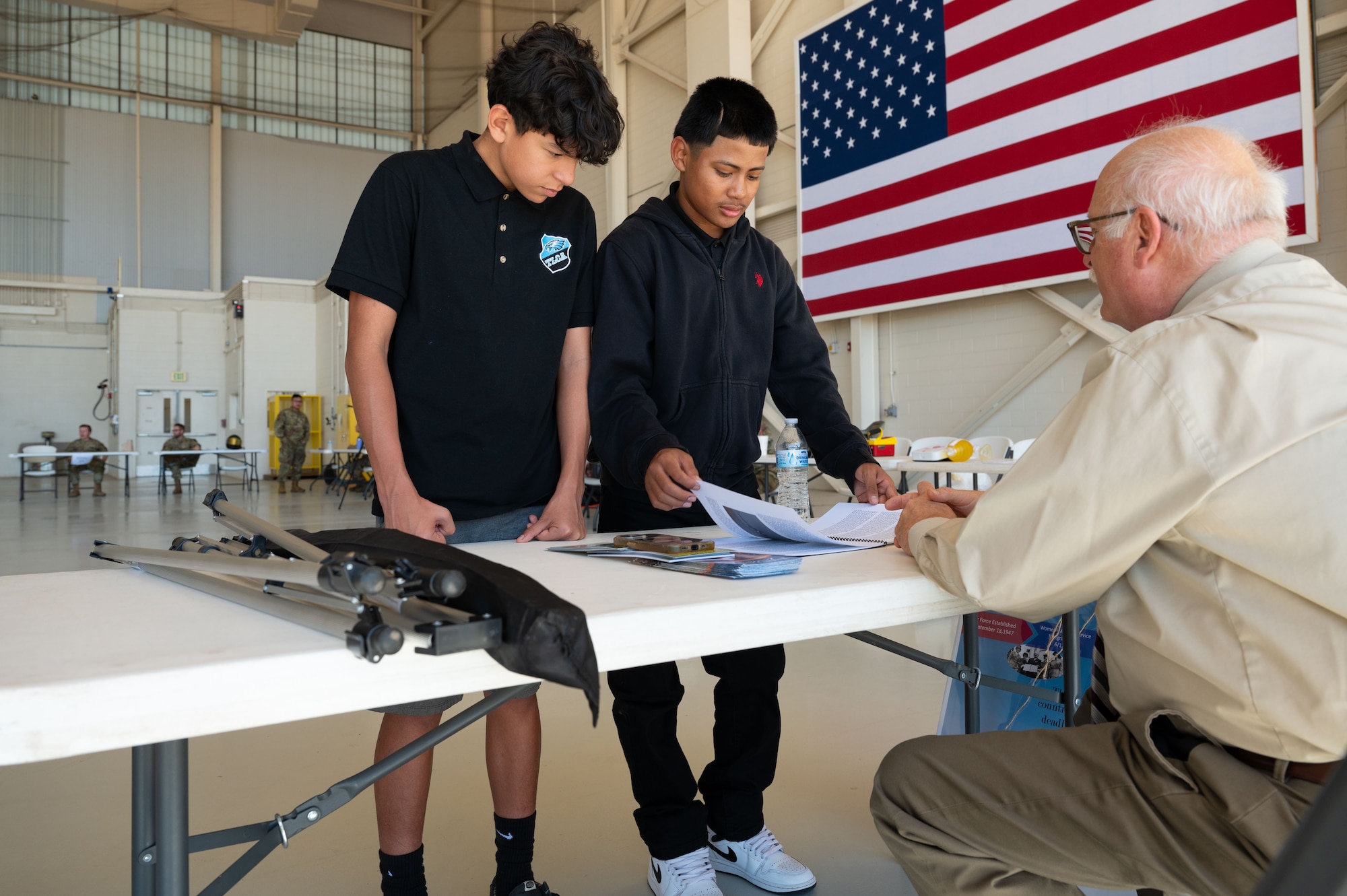 Abilene students speak with Dennis Berger, 7th Bomb Wing historian, during a career fair at Dyess Air Force Base, Texas, Oct. 24, 2024. Career fairs give an opportunity to introduce students to the various career opportunities available within the Air Force. (U.S. Air Force photo by Airman 1st Class Emma Anderson)