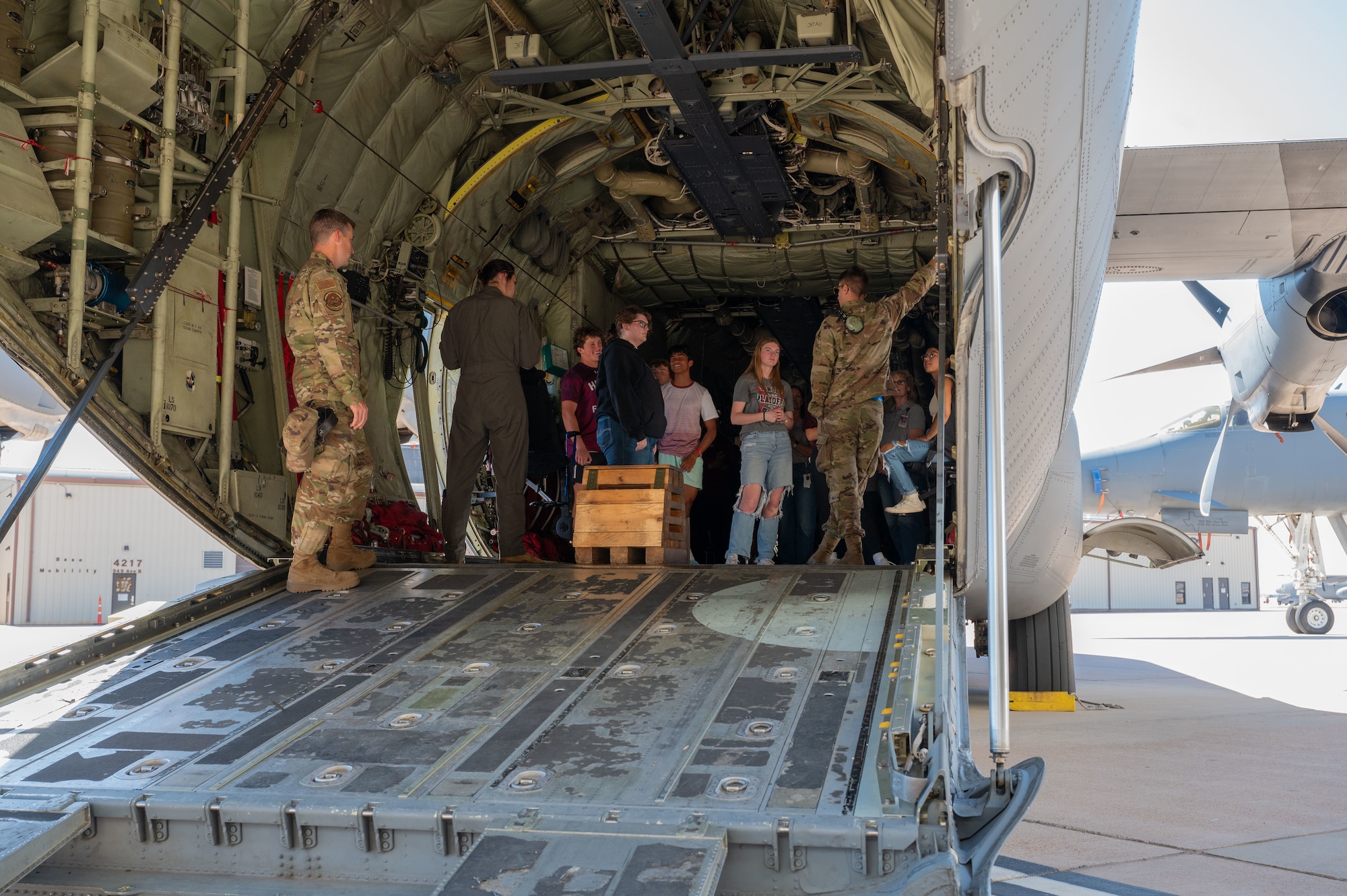 Abilene students tour a C-130J Super Hercules during a career fair at Dyess Air Force Base, Texas, Oct. 24, 2024. Students observed military aircraft and vehicles and spoke with various service members about their jobs.  (U.S. Air Force photo by Airman 1st Class Emma Anderson)
