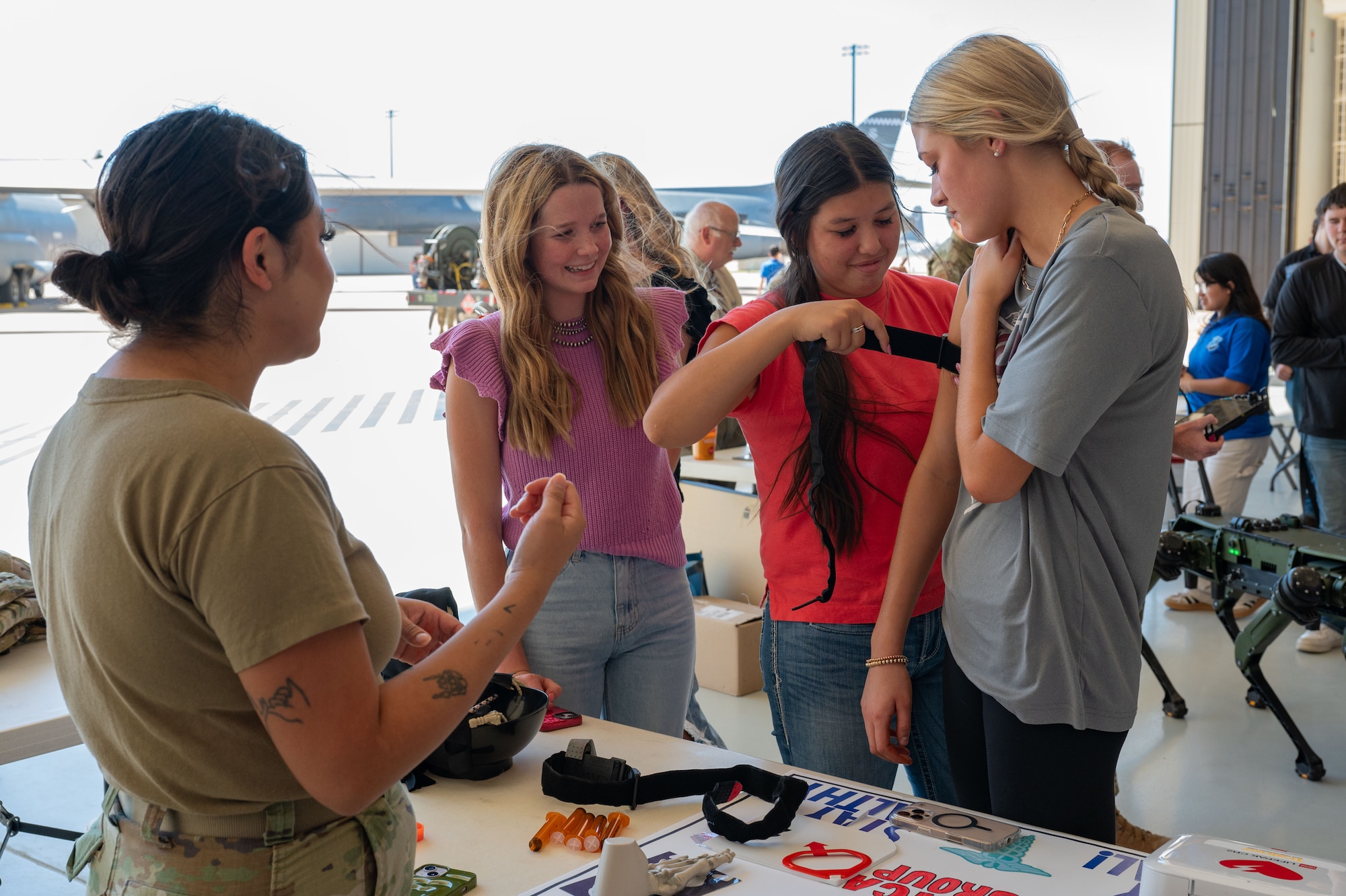 Abilene students learn how to apply a tourniquet during a career fair at Dyess Air Force Base, Texas, Oct. 24, 2024. Attendees spoke with active-duty members and were given insights into the skills, training, and benefits associated within the Air Force. (U.S. Air Force photo by Airman 1st Class Emma Anderson)