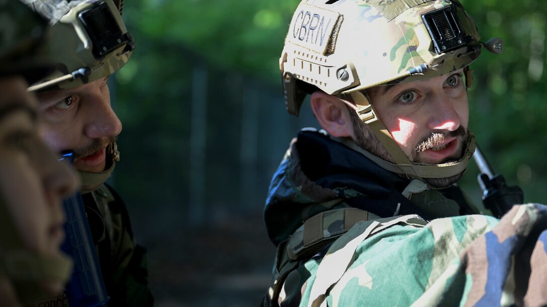 U.S. Air Force Senior Airman Samuel Baker, operations team member assigned to the 316th Civil Engineer Squadron, gives direction to his teammates during a Chemical, Biological, Radiological, and Nuclear training exercise at Joint Base Andrews, Md., Aug. 23, 2024. Baker's leadership in navigating the complex scenarios helped ensure team members stay aligned and effectively execute their roles. (U.S. Air Force photo by Staff Sgt. Isaac March)