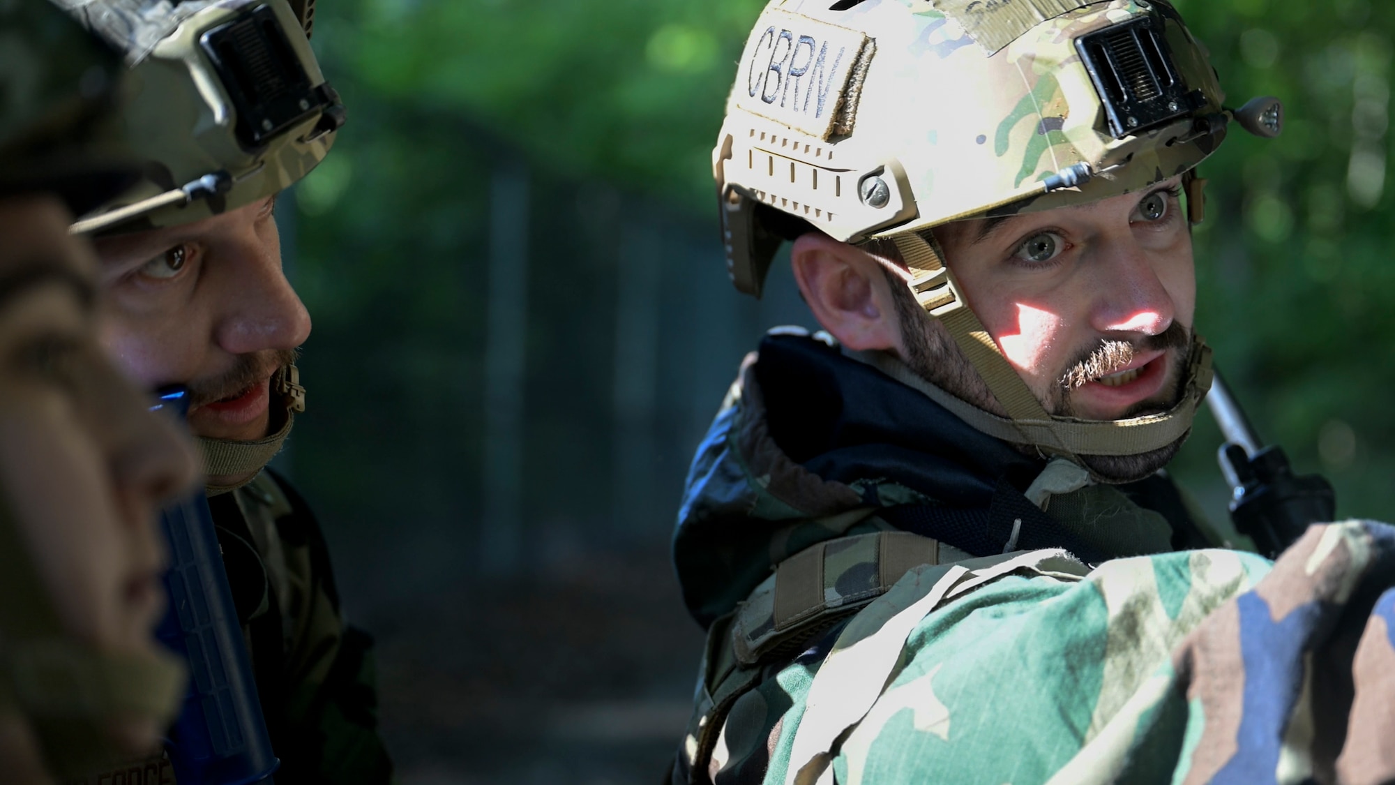 U.S. Air Force Senior Airman Samuel Baker, operations team member assigned to the 316th Civil Engineer Squadron, gives direction to his teammates during a Chemical, Biological, Radiological, and Nuclear training exercise at Joint Base Andrews, Md., Aug. 23, 2024. Baker's leadership in navigating the complex scenarios helped ensure team members stay aligned and effectively execute their roles. (U.S. Air Force photo by Staff Sgt. Isaac March)
