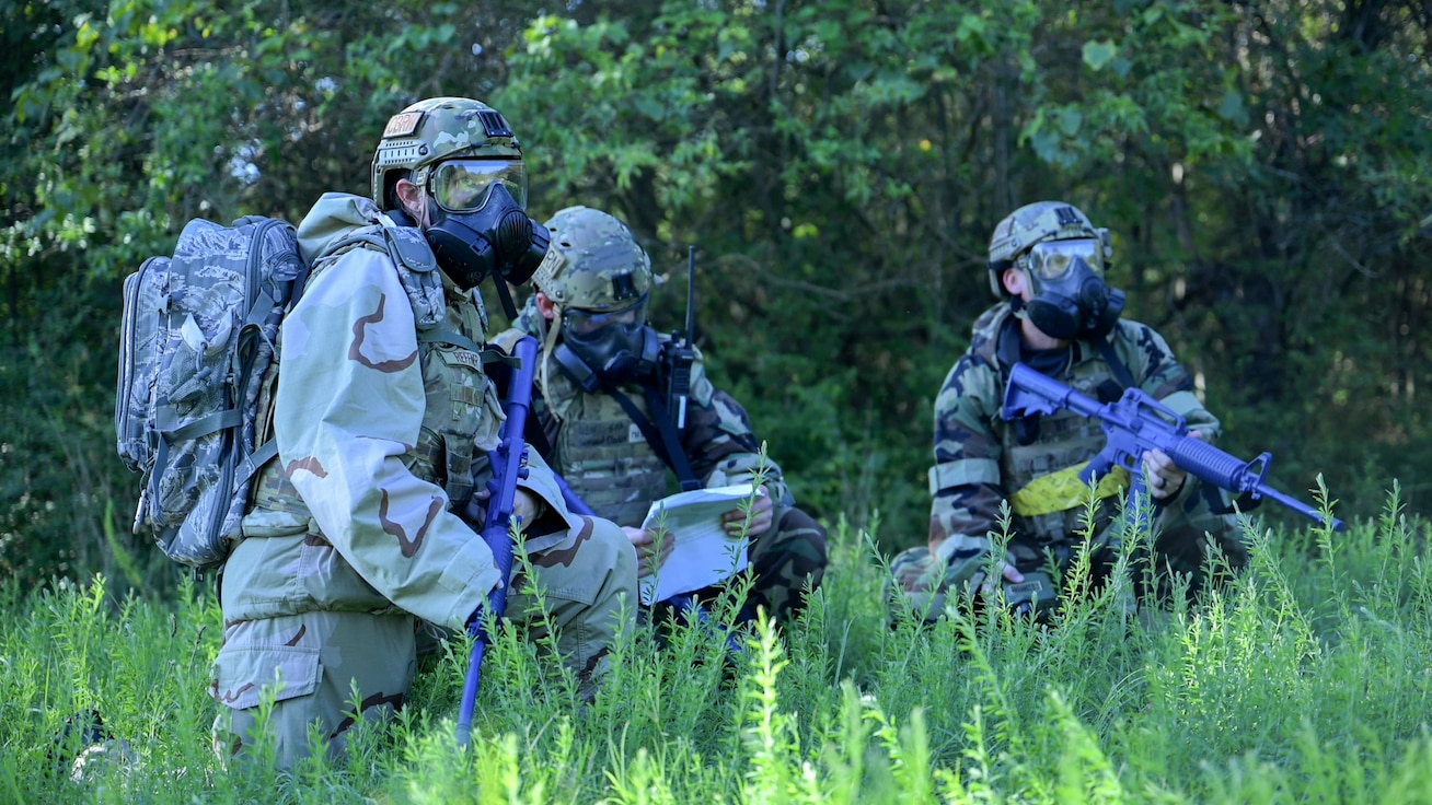 From left, U.S. Air Force 1st Lt. Maria Reffner, flight commander at the Installation Office of Emergency Management, 316th Civil Engineer Squadron; Senior Airman Samuel Baker, operations team member; and Senior Airman Steven Fazakerley, training team member, conduct reconnaissance during a Chemical, Biological, Radiological, and Nuclear training exercise at Joint Base Andrews, Md., Aug. 23, 2024. The exercise tested Airmen's abilities to operate in full protective gear while responding to simulated CBRN threats. (U.S. Air Force photo by Staff Sgt. Isaac March)