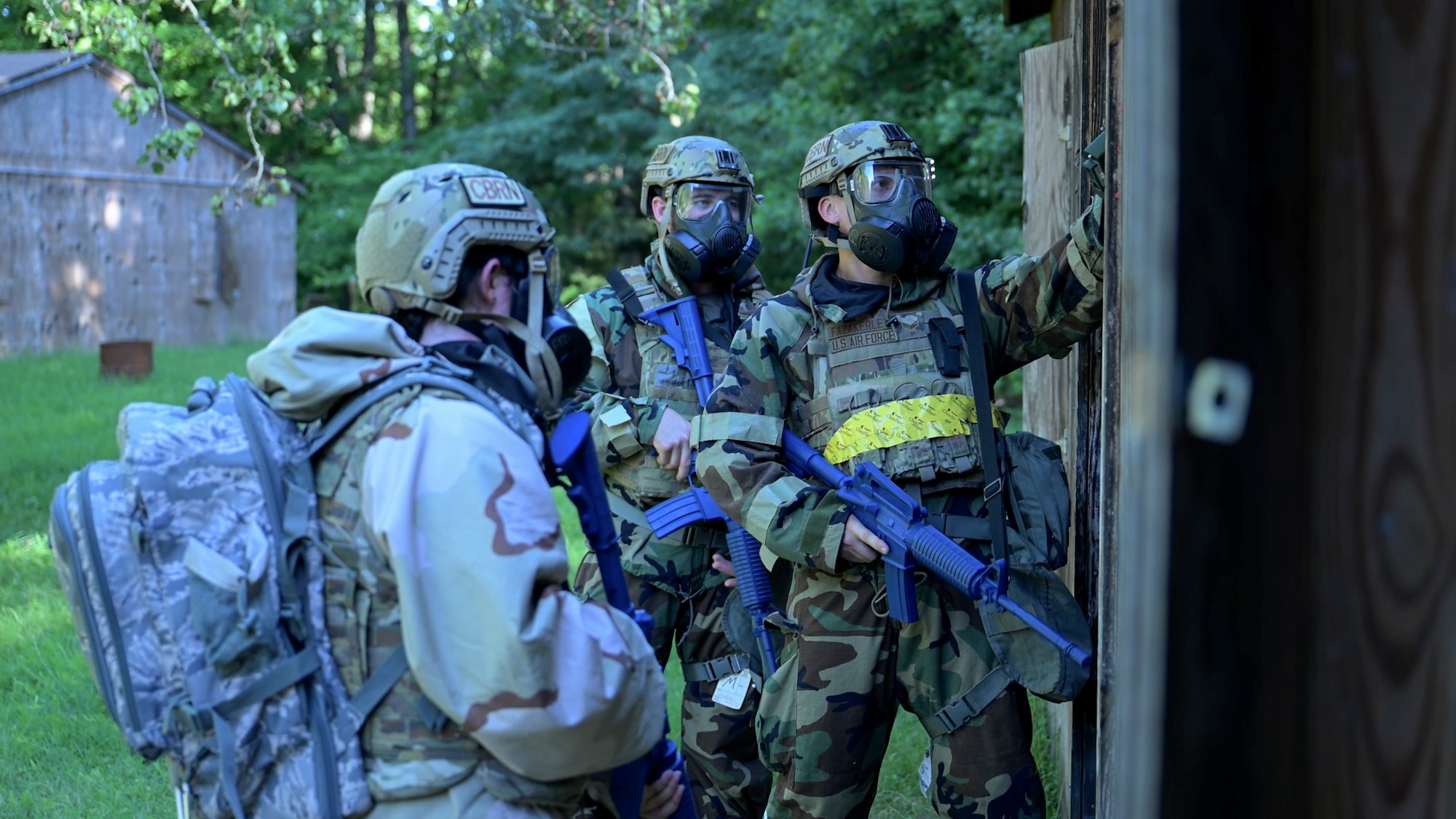 U.S. Air Force Senior Airman Steven Fazakerley, training team member; 1st Lt. Maria Reffner, flight commander, Installation Office of Emergency Management; and Senior Airman Samuel Baker, operations team member, all assigned to the 316th Civil Engineer Squadron, use detection devices to check an entryway for potential threats during a Chemical, Biological, Radiological, and Nuclear training exercise at Joint Base Andrews, Md., Aug. 23, 2024. The exercise emphasized threat detection and safe entry procedures to ensure mission success in hazardous environments. (U.S. Air Force photo by Staff Sgt. Isaac March)