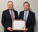 Andrew Lochli, Defense Counterintelligence and Security Agency assistant director for Counterintelligence and Insider Threat, presents the 2023 Jack Donnelly Award for Excellence in Counterintelligence to Robert Trono, Lockheed Martin Corp. vice president and chief security officer.