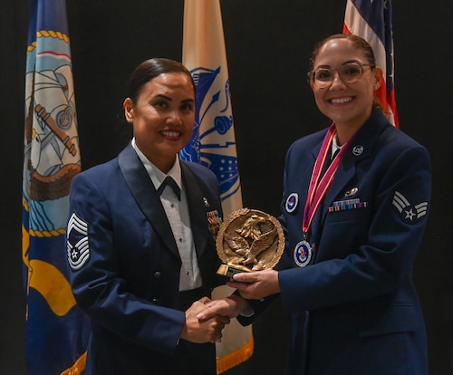 U.S. Air Force Chief Master Sgt. Catherine Gaco-Escalera, 17th Medical Group senior enlisted leader, presents the Distinguished Graduate Award to Senior Airman Mallory Creech, 315th Training Squadron, at the Powell Event Center, Goodfellow Air Force Base, Texas, Oct. 24, 2024. The Distinguished Graduate Award recognizes the student who is in the top 10 percent of their class based on performance tasks, peer stratifications and the capstone exercise.  (U.S. Air Force photo by Airman 1st Class James Salellas)