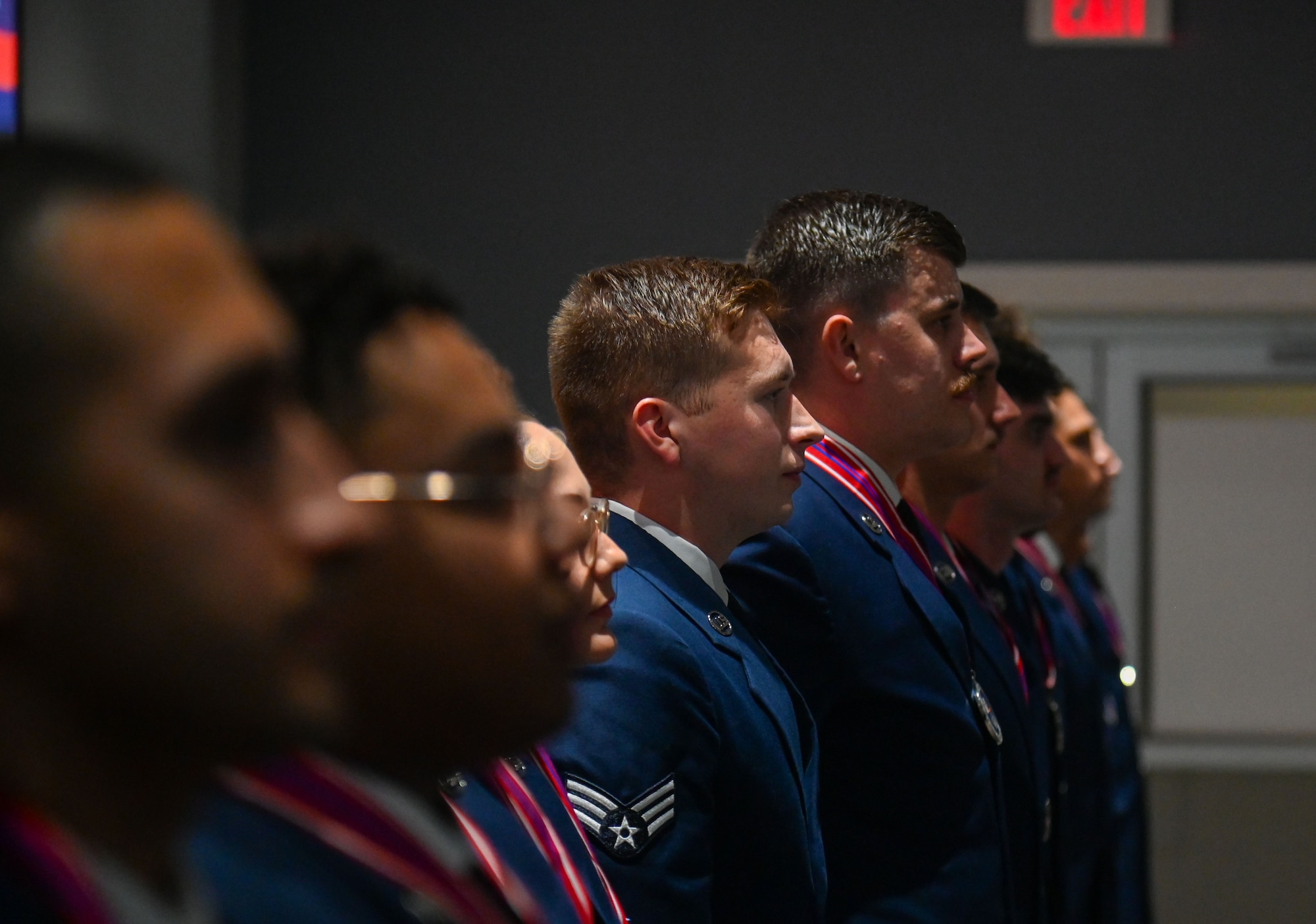 Members of the Airman Leadership School Class 24-G, stand at the position of attention before singing “The U.S. Air Force” at the end of their graduation at the Powell Event Center, Goodfellow Air Force Base, Texas, Oct. 24, 2024. “The U.S. Air Force” is the official song of the United States Air Force. (U.S. Air Force photo by Airman 1st Class James Salellas)