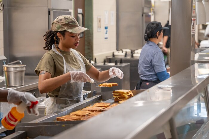 Reserve Airman prepares French toast for breakfast.