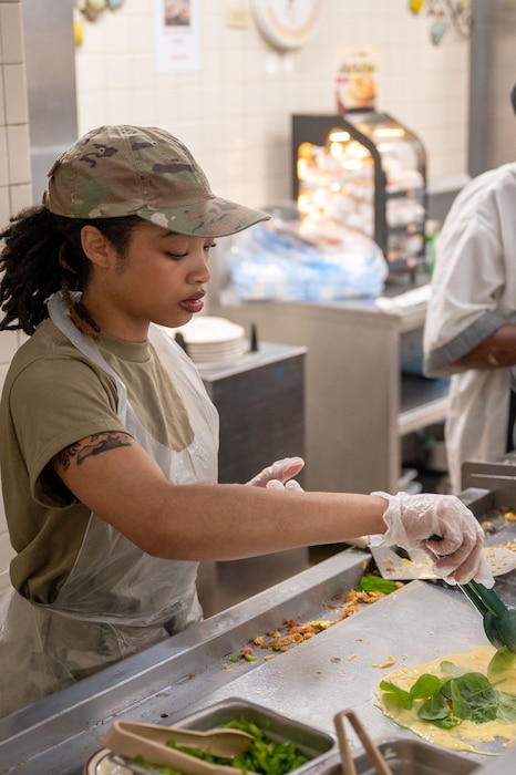 Reserve Airman prepares an omelet for a breakfast meal.