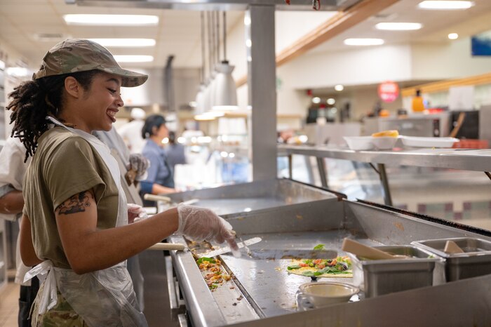 Reserve Airman prepares an omelet for a breakfast meal.