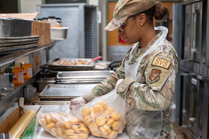 Reserve Airman prepares hashbrowns for breakfast.