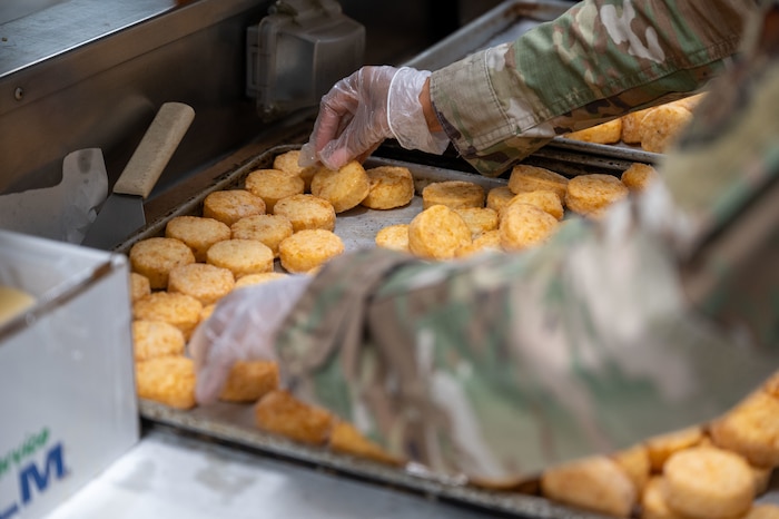 Reserve Airman prepares hashbrowns for breakfast.