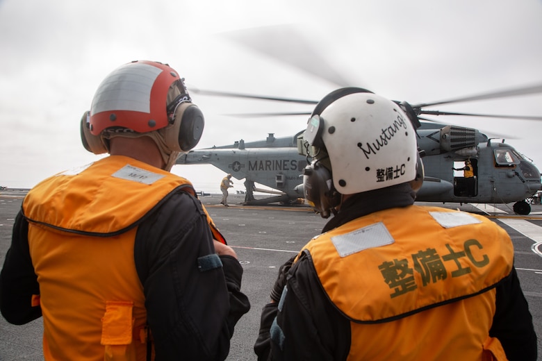 A U.S. Marine Corps CH-53E Super Stallion helicopter with Marine Heavy Helicopter Squadron (HMH) 466, Marine Aircraft Group 16, 3rd Marine Aircraft Wing, delivers a Mobile Cleaning Recovery Recycle System to the Japan Maritime Self-Defense Force Izumo-class multi-functional destroyer JS Kaga (DDH-184), off the coast of Southern California, Oct. 25, 2024. The CH-53E aircrew transported the MCRRS, a specialized cleaning system for restoring friction on flight deck non-skid surfaces, in support of F-35B Lightning II developmental testing onboard the JS Kaga.