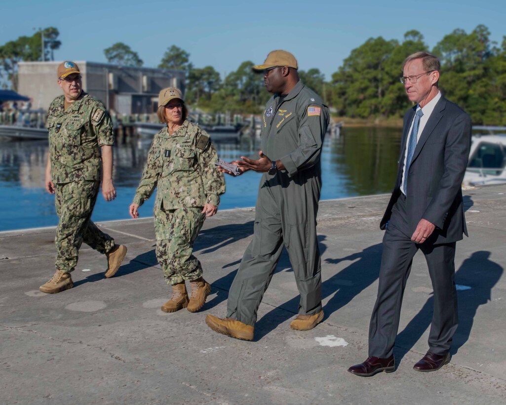 (center right) Commander Michael Mosi, Naval Support Activity Panama City commanding officer, talks with Chief of Naval Operations Adm. Lisa Franchetti as Capt. David Back, Naval Surface Warfare Center Panama City Division (NSWC PCD) commanding officer, and Dr. Peter Adair, NSWC PCD technical director, lead their portion of the admiral’s tour, Oct. 24. The visit allowed Franchetti to see how NSWC PCD, one of the Navy’s premiere research, development, test and evaluation laboratories, supports the fleet through capabilities including mine warfare, expeditionary warfare, robotics, autonomous systems, and naval special warfare. (U.S. Navy photo by Eddie Green)