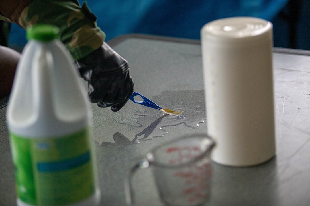 U.S. Marine Corps Lance Cpl. Daymond Velasquez Andrade, a chemical, biological, radiological, and nuclear defense (CBRN) specialist assigned to Marine Wing Support Squadron 171, Marine Aircraft Group 12, and a New York native, collects a sample of an unknown substance during an internal training on Marine Corps Air Station Iwakuni, Japan, Sept. 6, 2024. As CBRN Defense Specialists, Marines are trained to respond to and clear areas with possible CBRN hazards in addition to training units in general CBRN information, identification, and response. (U.S. Marine Corps photo by Sgt. Phuchung Nguyen)