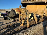 Alaska Organized Militia members assigned to Joint Task Force - Kotzebue assist the Arctic Circle community with recovery efforts, Oct. 26, 2024, following a recent storm that caused severe flooding along Alaska’s West Coast. The 11-member team, including personnel from the Alaska Air and Army National Guard and the Alaska State Defense Force, was activated by the State Emergency Operations Center to support response and recovery efforts.