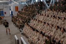 U.S. Marine Corps Sgt. Tysen Schmidt, a Marine Corps instructor of water survival, with Support Battalion, Recruit Training Regiment, gives a brief to recruits with Fox Company, 2nd Recruit Training Battalion, before they conduct a swim qualification event at Marine Corps Recruit Depot San Diego, California, Oct. 21, 2024. The basic swim qualification consists of a 25-meter swim, tower jump into the water, four-minute tread, 25-meter pack swim, and an underwater gear shed. (U.S. Marine Corps photo by Cpl. Sarah M. Grawcock)