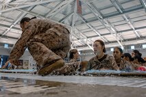 U.S. Marine Corps recruits with Fox Company, 2nd Recruit Training Battalion, exit the pool during a swim qualification event at Marine Corps Recruit Depot San Diego, California, Oct. 21, 2024. The basic swim qualification consists of a 25-meter swim, tower jump into the water, four-minute tread, 25-meter pack swim, and an underwater gear shed. (U.S. Marine Corps photo by Cpl. Sarah M. Grawcock)