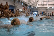 U.S. Marine Corps recruits with Fox Company, 2nd Recruit Training Battalion, participate in a swim qualification event at Marine Corps Recruit Depot San Diego, California, Oct. 21, 2024. The basic swim qualification consists of a 25-meter swim, tower jump into the water, four-minute tread, 25-meter pack swim, and an underwater gear shed. (U.S. Marine Corps photo by Cpl. Sarah M. Grawcock)
