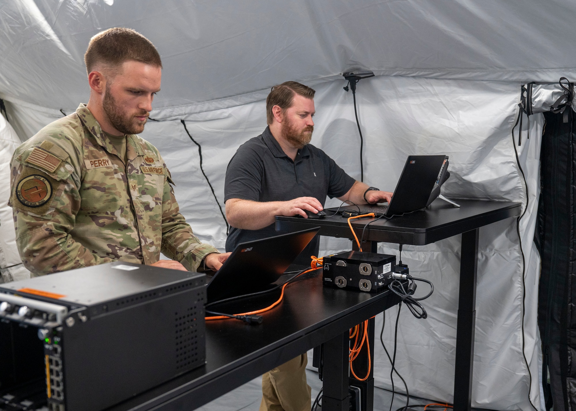 Photo of Air Force personnel checking computer set-ups.