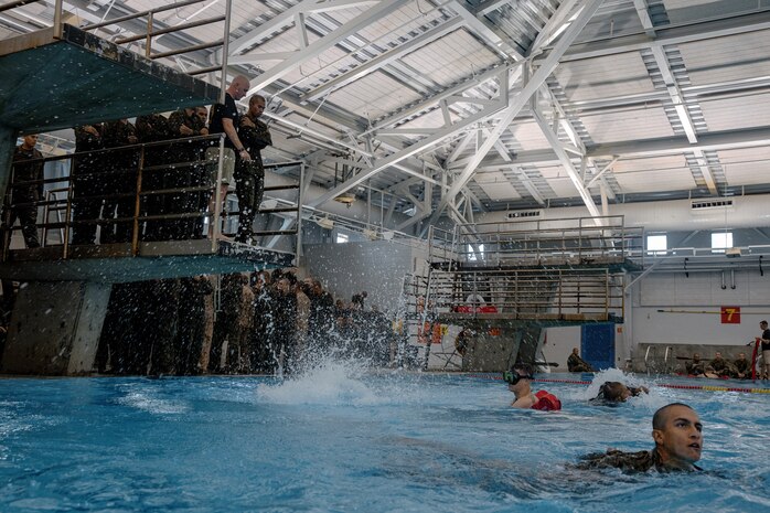 U.S. Marine Corps recruits with Fox Company, 2nd Recruit Training Battalion, participate in a swim qualification event at Marine Corps Recruit Depot San Diego, California, Oct. 21, 2024. The basic swim qualification consists of a 25-meter swim, tower jump into the water, four-minute tread, 25-meter pack swim, and an underwater gear shed. (U.S. Marine Corps photo by Cpl. Sarah M. Grawcock)