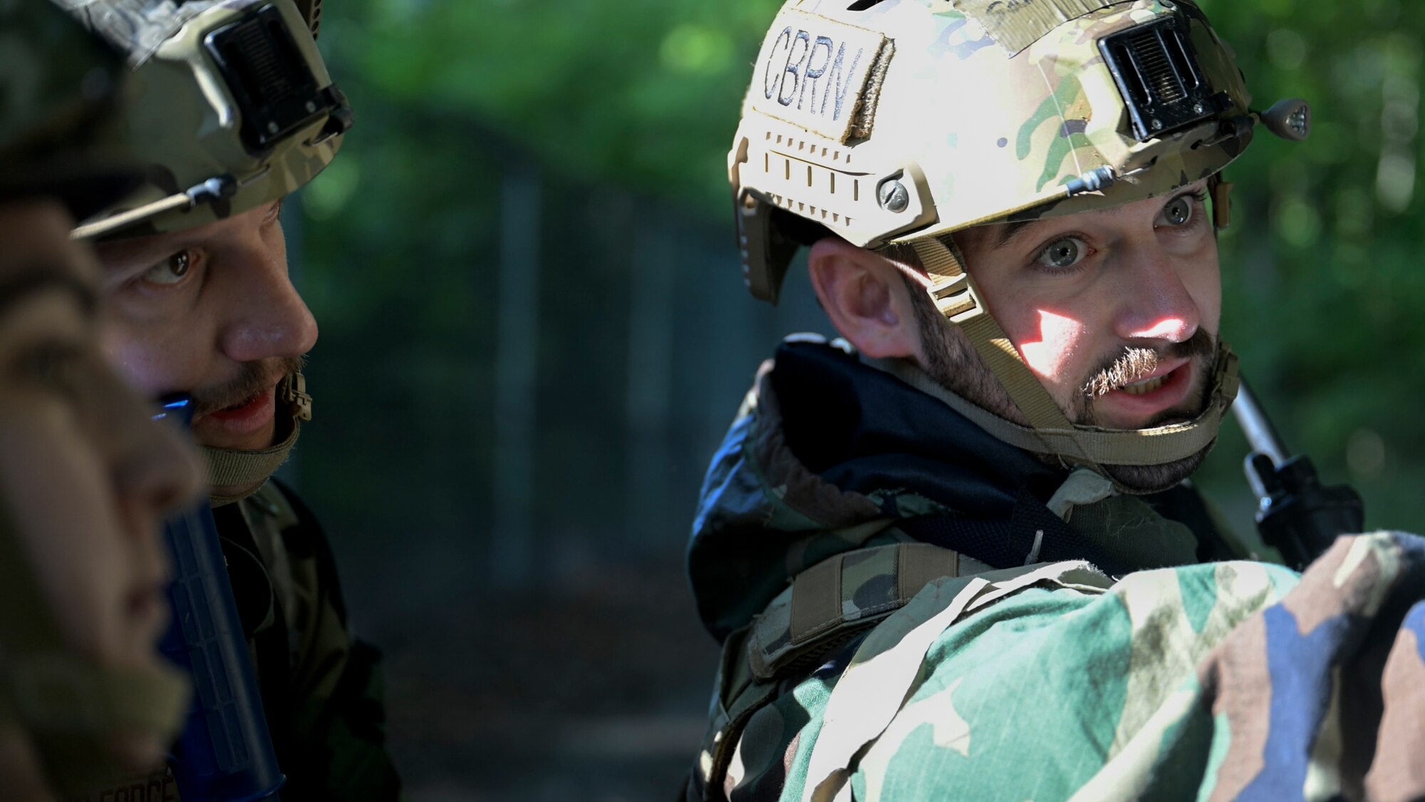 U.S. Air Force Senior Airman Samuel Baker, operations team member assigned to the 316th Civil Engineer Squadron, gives direction to his teammates during a Chemical, Biological, Radiological, and Nuclear training exercise at Joint Base Andrews, Md., Aug. 23, 2024. Baker's leadership in navigating the complex scenarios helped ensure team members stay aligned and effectively execute their roles. (U.S. Air Force photo by Staff Sgt. Isaac March)