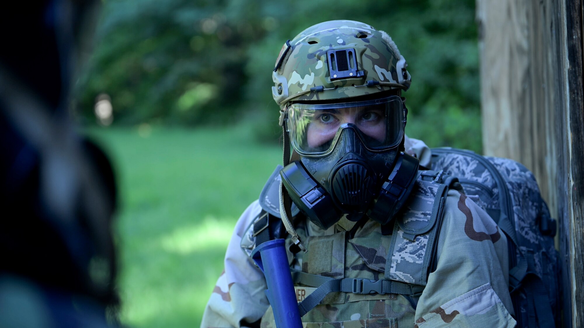U.S. Air Force 1st Lt. Maria Reffner, flight commander at the Installation Office of Emergency Management, 316th Civil Engineer Squadron, waits for the signal to enter a building during a Chemical, Biological, Radiological, and Nuclear training exercise at Joint Base Andrews, Md., Aug. 23, 2024. The exercise involved precision timing and communication, critical for ensuring safe entry into potentially hazardous areas. (U.S. Air Force photo by Staff Sgt. Isaac March)