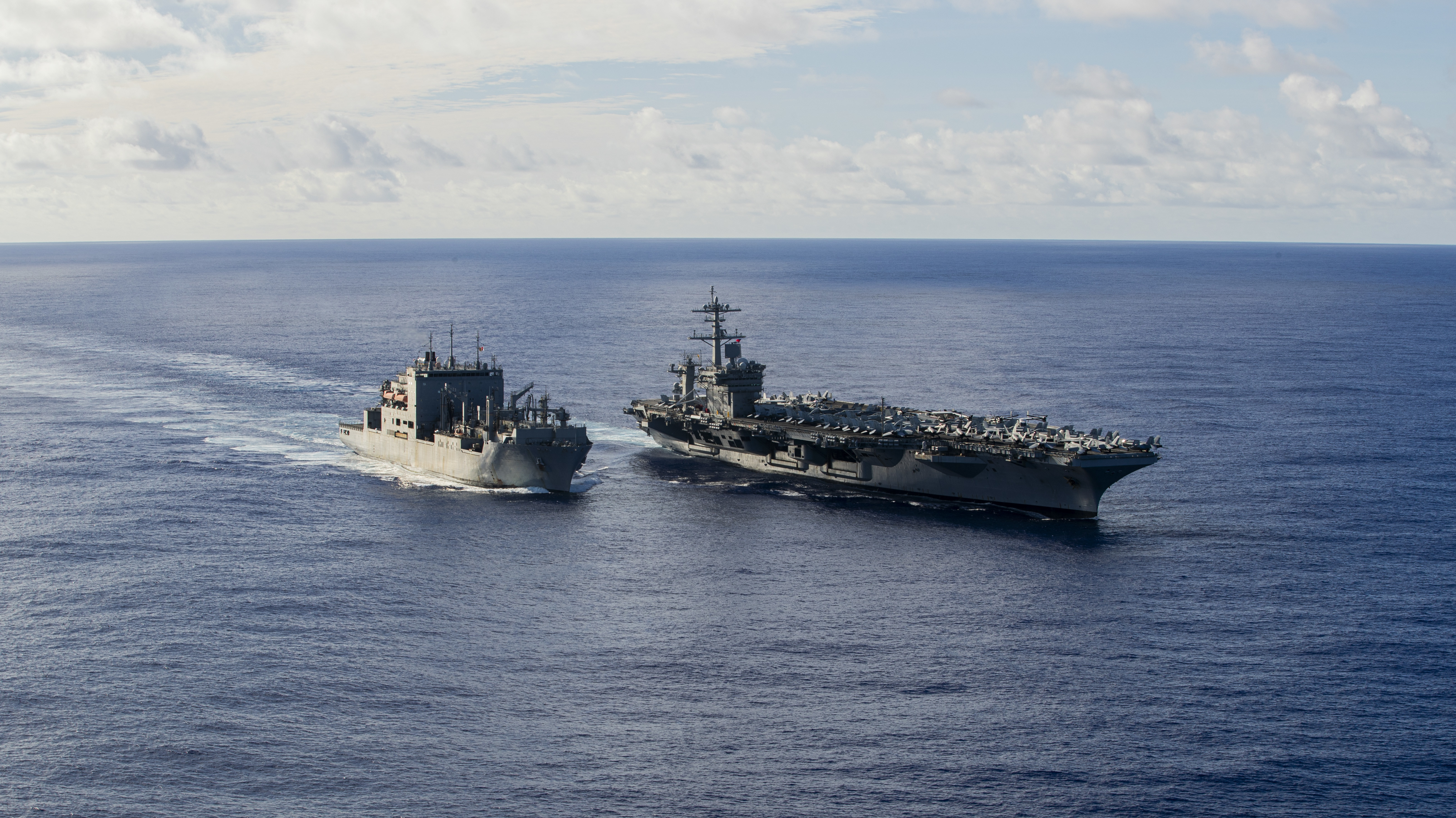 Nimitz-class aircraft carrier USS George Washington (CVN 73) and Lewis and Clark-class dry cargo and ammunition ship USNS Cesar Chavez (T-AKE 14) conduct a replenishment-at-sea while underway in the Pacific Ocean, Oct. 25, 2024.