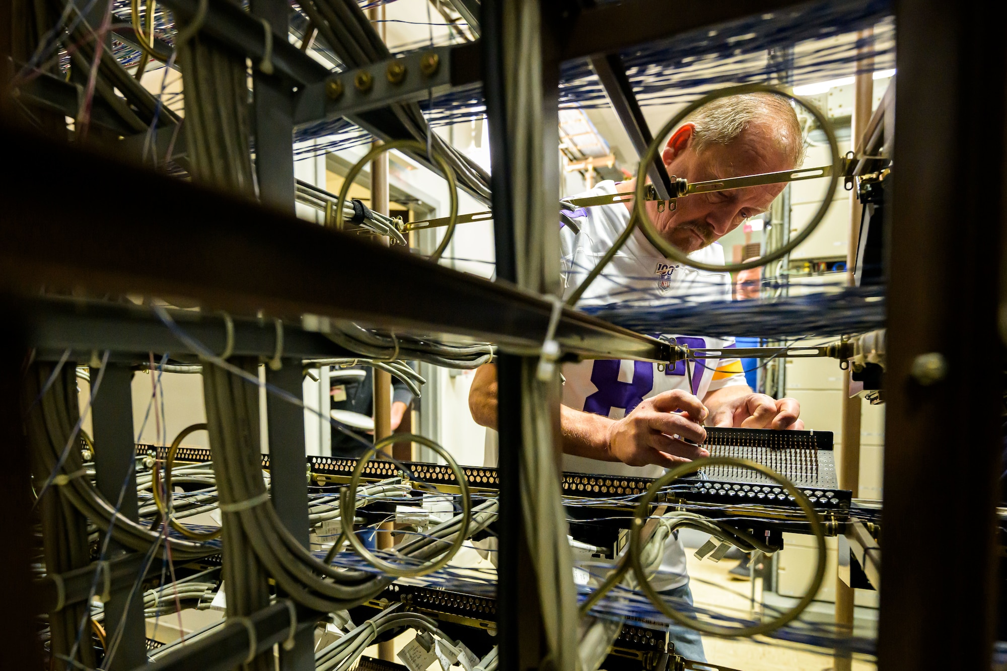 Burke Kilburn, 75th Communications and Information Directorate, looks at a component of a  deactivated analog telecommunications system at Hill Air Force Base, Utah. The directorate transitioned to a fully digital system that requires less resources to manage while providing more capabilities.
