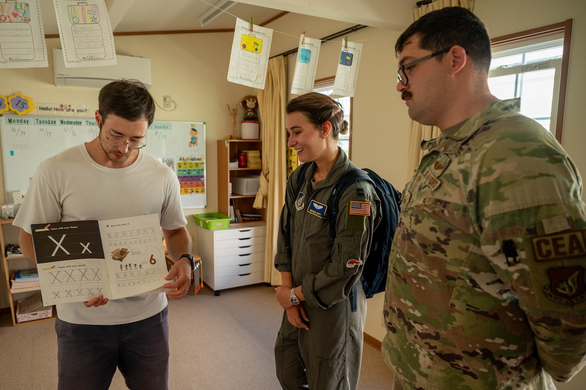 A teacher shows the OCD team the students work.